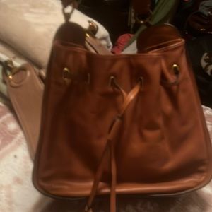 You are looking at a new with tag Frye pull string hand bag never used